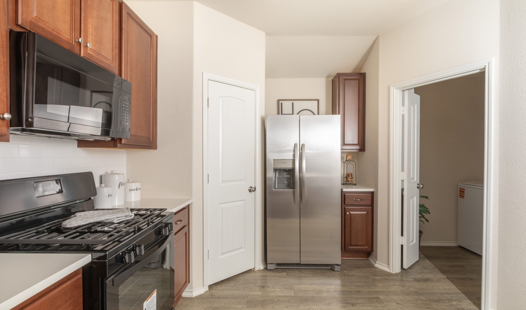 kitchen with ample counter-space, modern appliances and bright lighting